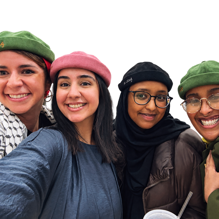 Four friends smiling in Suede Skullies in green, pink and black